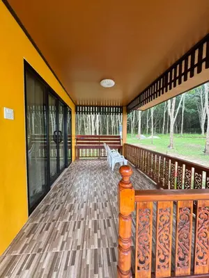 a balcony of a house with a bench on it at SeaMountain Kohyao Noi in Ko Yao Noi