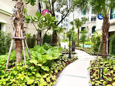a walkway in front of a building with plants at The Legendary Apartment 408 in Bang Tao Beach