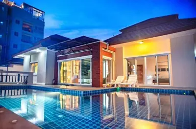 a swimming pool in front of a house at ZJ Garden Pool Villa in Phuket Town