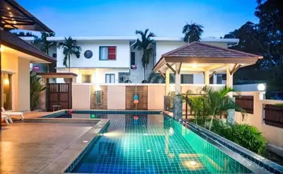 a swimming pool in front of a house at ZJ Garden Pool Villa in Phuket Town