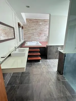 a large bathroom with a tub and a sink at ZJ Garden Pool Villa in Phuket Town