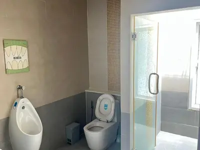 a bathroom with a urinal and a toilet and a sink at ZJ Garden Pool Villa in Phuket Town