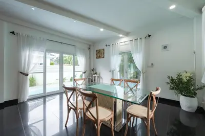 a dining room with a glass table and chairs at Platinum Villa Rawai 76 in Rawai Beach