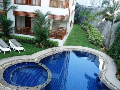 a resort with a swimming pool and a building at 41 квадратный метр, апартамент на пляже Сурин in Surin Beach