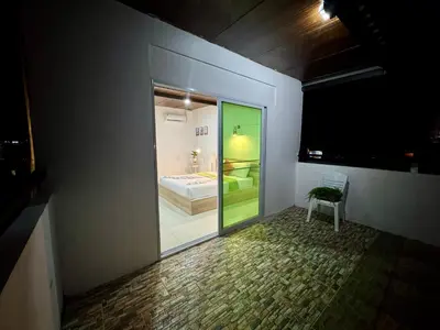 a room with a view of a bedroom through a glass door at LimeTree Loft Guesthouse in Patong Beach
