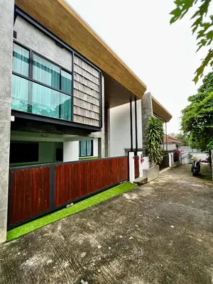 a house with a wooden fence in front of a driveway at Private 2-Bedroom Pool Villa in Rawai, Phuket in Rawai Beach