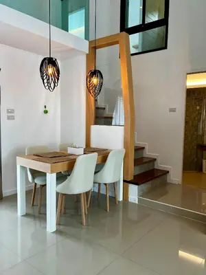 a dining room with a wooden table and white chairs at Private 2-Bedroom Pool Villa in Rawai, Phuket in Rawai Beach