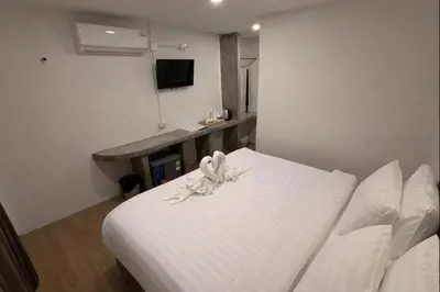 a bedroom with a white bed with a flower on it at HUG PHIPHI Resort in Phi Phi Don
