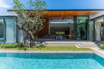 an external view of a house with a swimming pool at UltraLuxury 4BDR pool villa Botanica Foresta in Ban Phru Champa