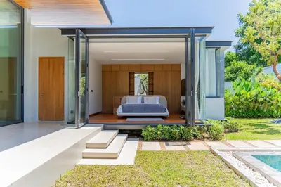a bedroom in a villa with a bed and a garden at UltraLuxury 4BDR pool villa Botanica Foresta in Ban Phru Champa