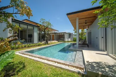 an infinity pool in the backyard of a house at UltraLuxury 4BDR pool villa Botanica Foresta in Ban Phru Champa