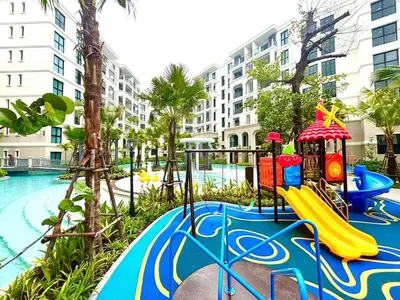 a playground with a slide next to a pool at The Legendary Apartment 209 in Bang Tao Beach