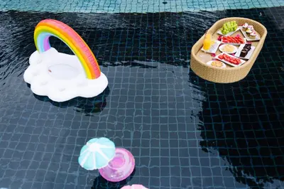 a toy boat and a rainbow in a swimming pool at Beautiful Patong Sea View 6 Bedroom Thai Luxury Villa Near Bar Street, Jungceylon in Patong Beach