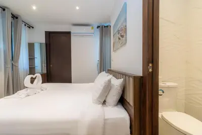 a hotel room with a bed and a bath tub at Beautiful Patong Sea View 6 Bedroom Thai Luxury Villa Near Bar Street, Jungceylon in Patong Beach