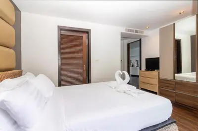 a bedroom with a white bed and a mirror at Beautiful Patong Sea View 6 Bedroom Thai Luxury Villa Near Bar Street, Jungceylon in Patong Beach