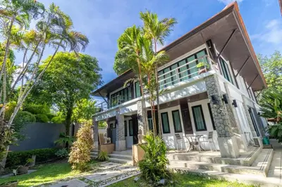 an exterior view of a house with palm trees at Beautiful Patong Sea View 6 Bedroom Thai Luxury Villa Near Bar Street, Jungceylon in Patong Beach
