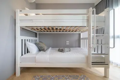 a bunk bed in a room with a white bunk bed at The Legendary Bang Tao 2-bedrooms apart #701 in Bang Tao Beach