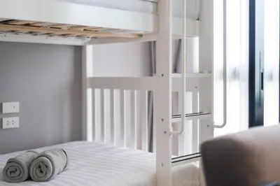 a bedroom with a bunk bed with towels on it at The Legendary Bang Tao 2-bedrooms apart #701 in Bang Tao Beach