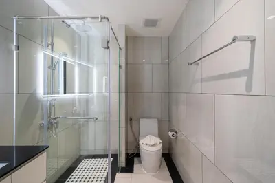 a bathroom with a glass shower and a toilet at Apartments 15 minutes walk from Bangtao Beach with a cinema in Phuket