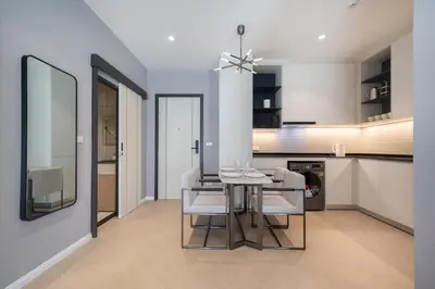 a kitchen and dining room with a table and chairs at Apartments 15 minutes walk from Bangtao Beach with a cinema in Phuket