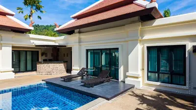 a villa with a swimming pool and a house at Genesis Elephant Villa in Rawai Beach