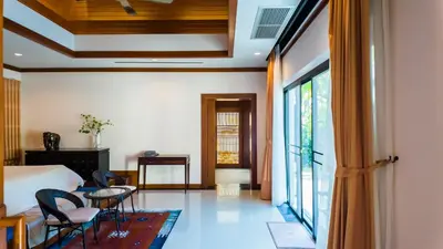 a hotel room with a bed and a window at Genesis Elephant Villa in Rawai Beach