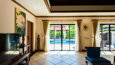 a living room with a door leading to a pool at Genesis Elephant Villa in Rawai Beach