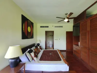 a bedroom with a bed and a ceiling fan at Apartment 2 bedrooms in Allamanda in Laguna Phuket