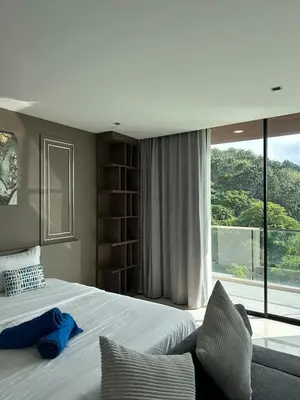 a bedroom with a large bed and a large window at The Viva Patong Sea view and Mountain views in Patong Beach