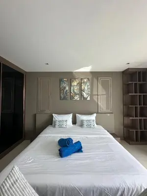 a large white bed with a blue towel on it at The Viva Patong Sea view and Mountain views in Patong Beach