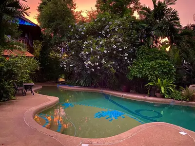a small swimming pool in a yard with trees at OASIS by Four Twenty in Chalong