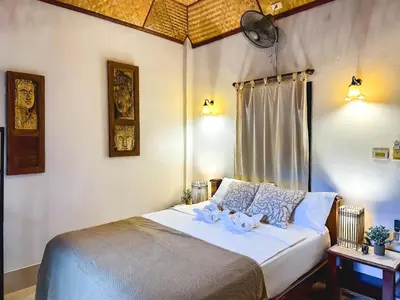 a bedroom with a bed with two stuffed animals on it at OASIS by Four Twenty in Chalong