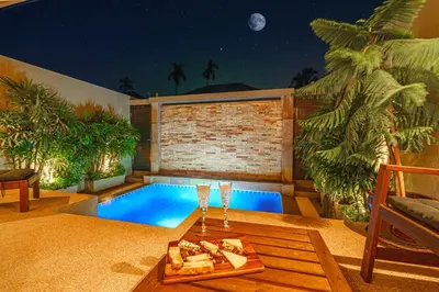 a pool with a tray of food on a table at The Residence One-Bedroom Villa in Ban Thalat Choeng Thale