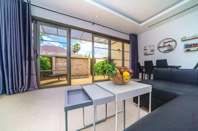 a living room with a couch and a table at The Residence One-Bedroom Villa in Ban Thalat Choeng Thale
