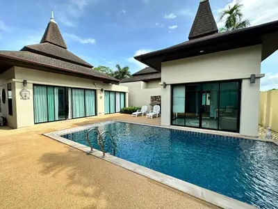 a swimming pool in front of a house at Luxury 3 Bed Cherngtalay Villa Pool close to Beaches Dec Holiday Specials in Ban Phru Champa