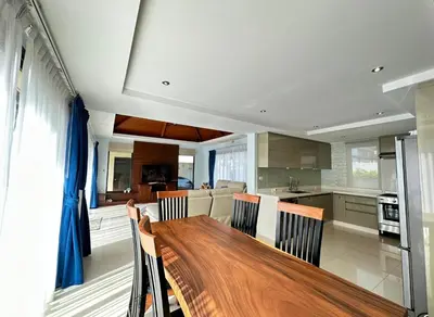 a kitchen with a long wooden table and chairs at Luxury 3 Bed Cherngtalay Villa Pool close to Beaches Dec Holiday Specials in Ban Phru Champa