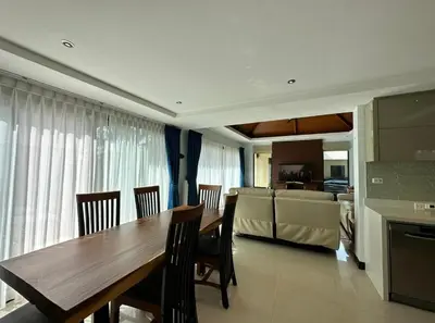 a kitchen and dining room with a wooden table and chairs at Luxury 3 Bed Cherngtalay Villa Pool close to Beaches Dec Holiday Specials in Ban Phru Champa