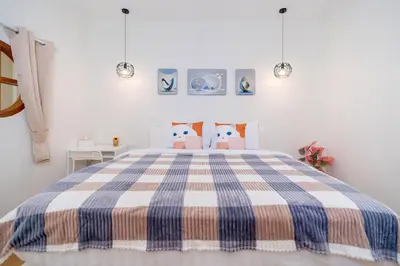 a bedroom with a blue and white bed with pillows at Cozy Home in heart of Patong in Patong Beach