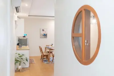 a mirror hanging on a wall in a room at Cozy Home in heart of Patong in Patong Beach