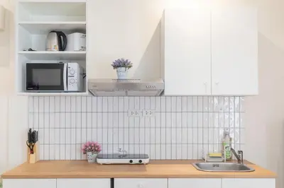 a kitchen counter with a sink and a microwave at Cozy Home in heart of Patong in Patong Beach