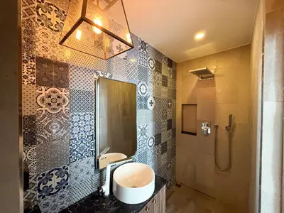 a bathroom with a sink and a shower at Palmyrah Surin Apartments by Mill in Surin Beach