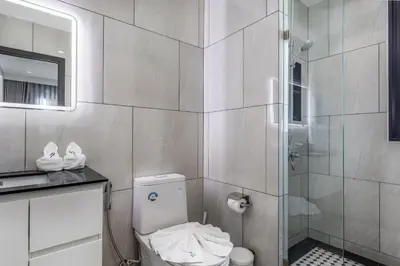 a bathroom with a toilet and a shower at Family Deluxe close to Bang Tao Beach in Bang Tao Beach
