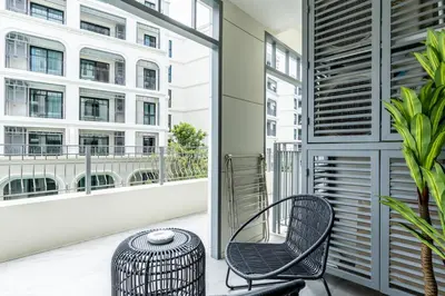 a balcony with two chairs and a table at Family Deluxe close to Bang Tao Beach in Bang Tao Beach