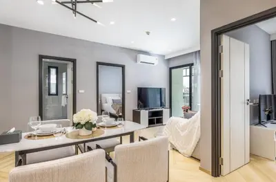 a dining room and living room with a table and chairs at Family Deluxe close to Bang Tao Beach in Bang Tao Beach