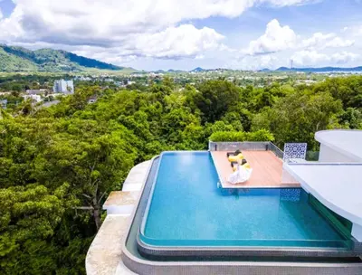 a swimming pool on the side of a building with at Pool Access 1 Bedroom Duplex UTL A107 near Nai Harn Beach in Rawai Beach