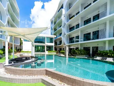 a swimming pool in front of a building at Pool Access 1 Bedroom Duplex UTL A107 near Nai Harn Beach in Rawai Beach