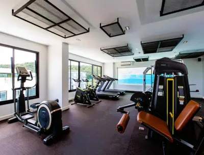 a gym with several treadmills and elliptical machines at Pool Access 1 Bedroom Duplex UTL A107 near Nai Harn Beach in Rawai Beach