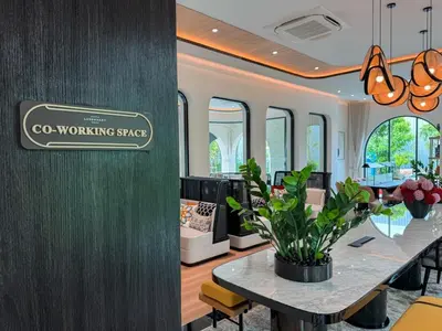a room with a table and a sign on a wall at Modern 1BR with Pool View The Title Legendary in Bang Tao Beach