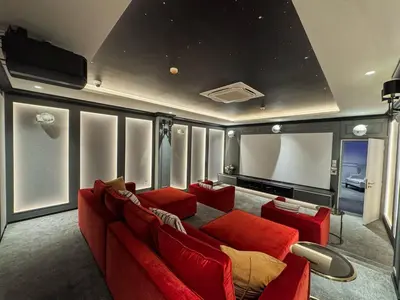 a living room with a red couch and a tv at Modern 1BR with Pool View The Title Legendary in Bang Tao Beach