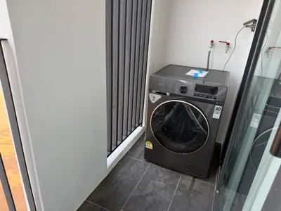 a washing machine in a room next to a window at New Studio in Bellevue Lagoon Phuket in Laguna Phuket